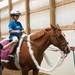 (left) Stephanie Webb, Taylor, rider Summer Paplin, 9 of Canton, and Susan Westhoff, Milan, laugh about a costumed Lion's player riding the Diva styled horse at the Harold and Kay Peplau Therapeutic Riding Center's Halloween Trick-or-Treat horse ride. (Tanya Moutzalias for AnnArbor.com)